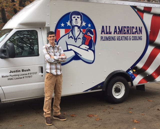 The owner of All American Plumbing Heating & Cooling posing in front of his truck
